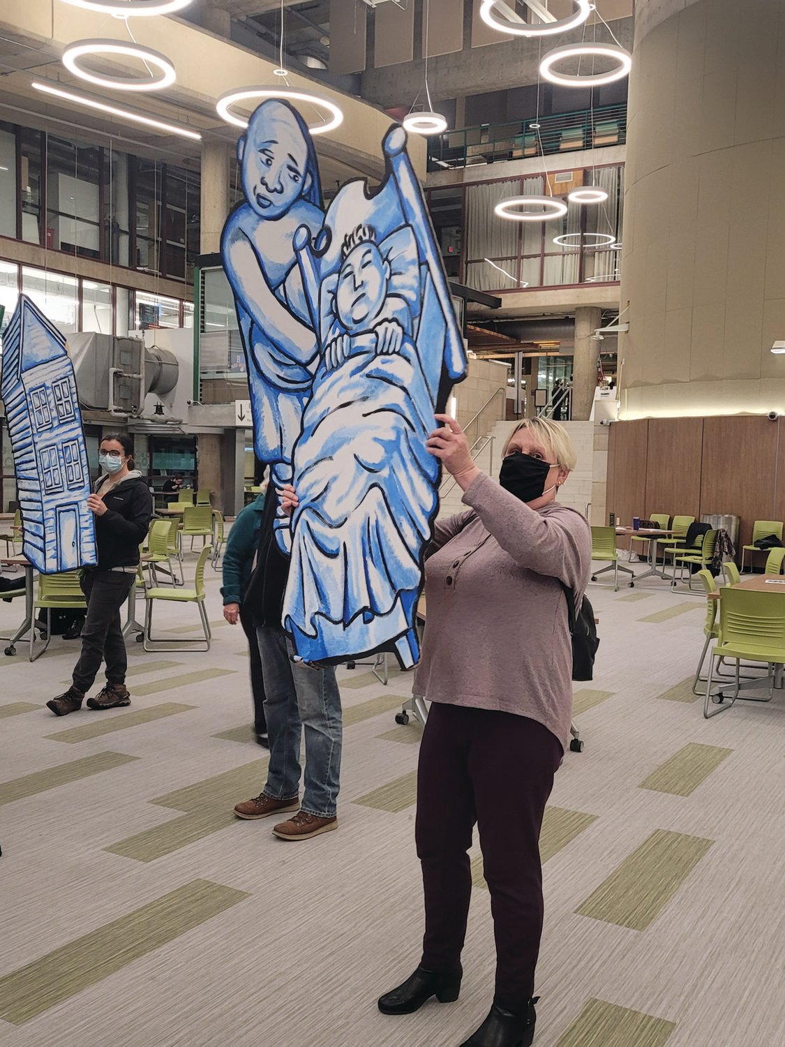 GIMME SHELTER: Members of the Rhode Island Homeless Advocacy Project carried life-size cutouts representing “unsheltered” Ocean State residents, during a RI 2030 public forum Tuesday night. 